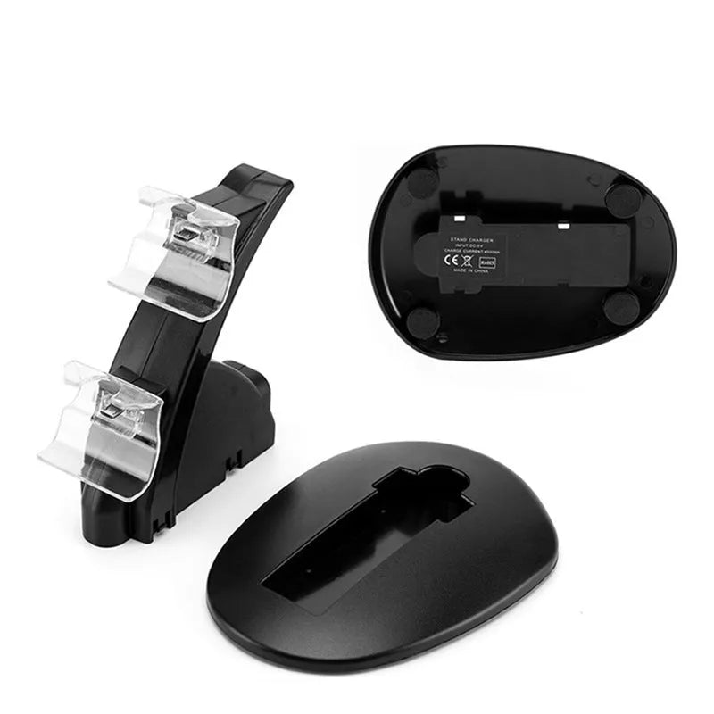 Black dual charging stand holding two Xbox One controllers upright for simultaneous USB charging.