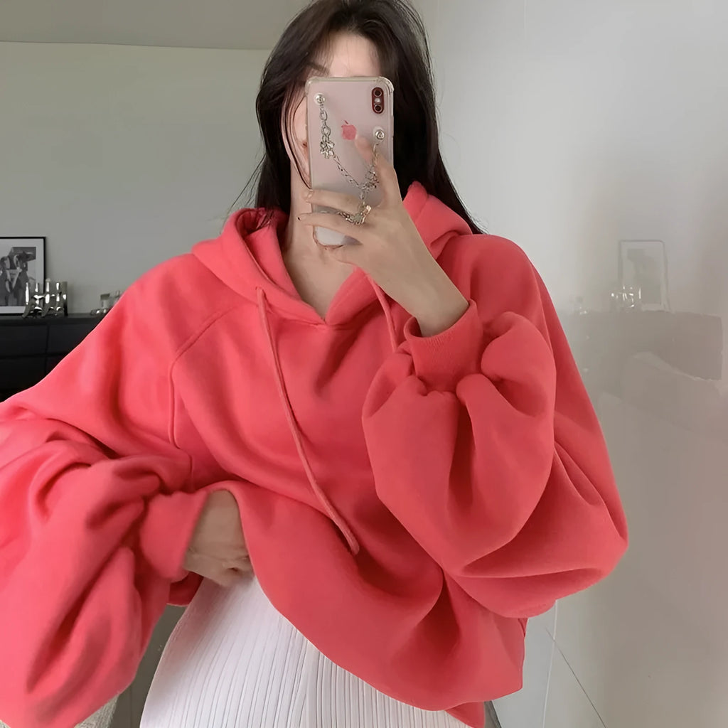 Watermelon red mulberry silk hooded sweater on a hanger, showing loose sleeveless fit.