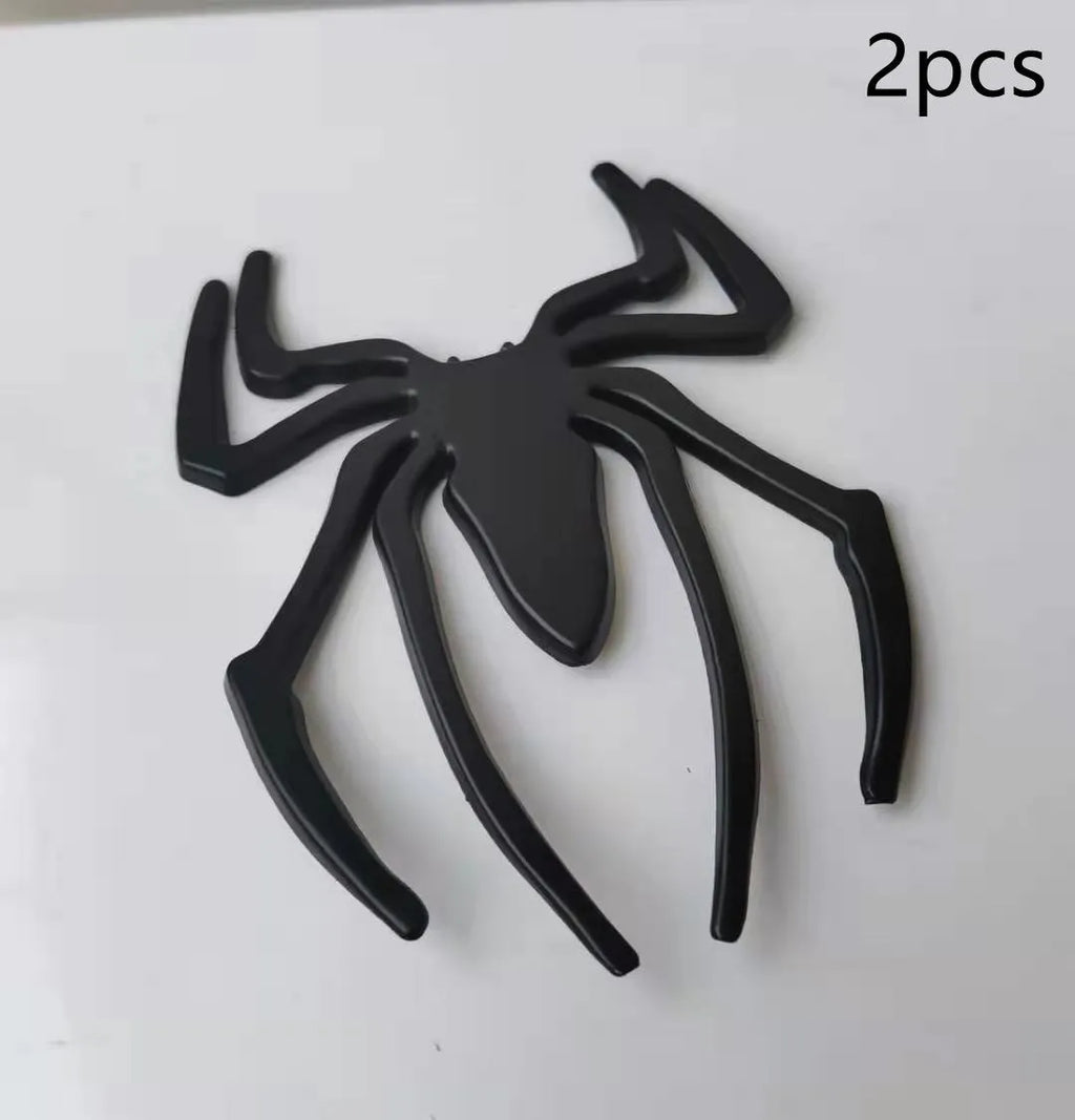 Three-dimensional metallic spider sticker in gold, silver, black, and red colours