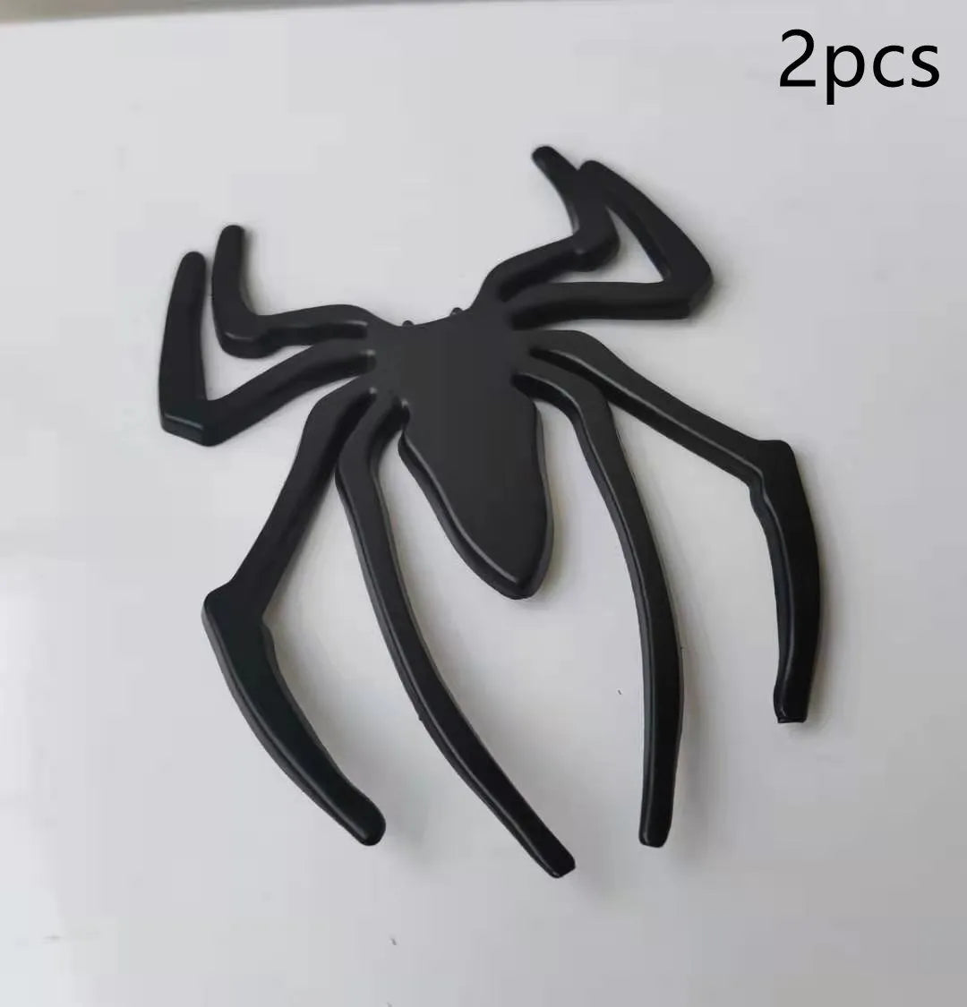 Three-dimensional metallic spider sticker in gold, silver, black, and red colours