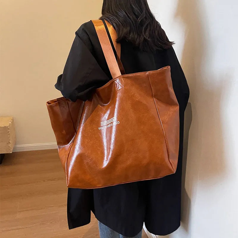 Large capacity PU tote bag for women in solid black, beige or brown, waterproof shoulder handbag for daily and travel use.