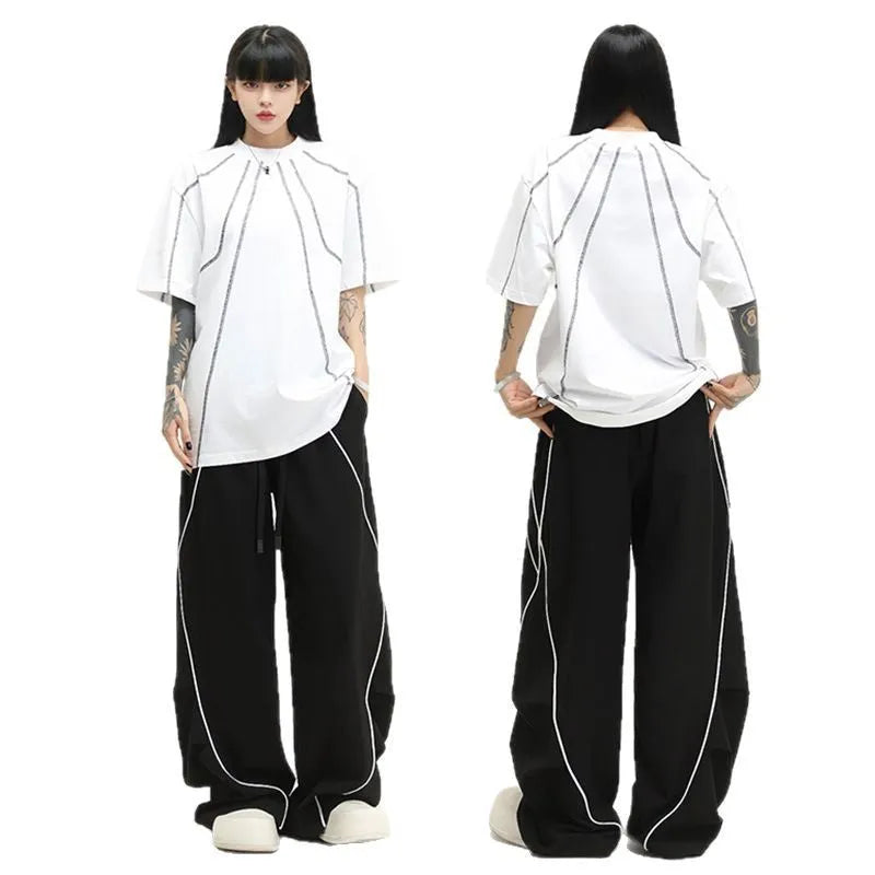 Black pleated wide-leg hip hop sports trousers with striped pattern and elasticated waist.