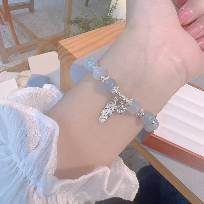 Korean style glass and coloured glaze crystal bracelet in feather XINGX blue moonlight colour with text detailing