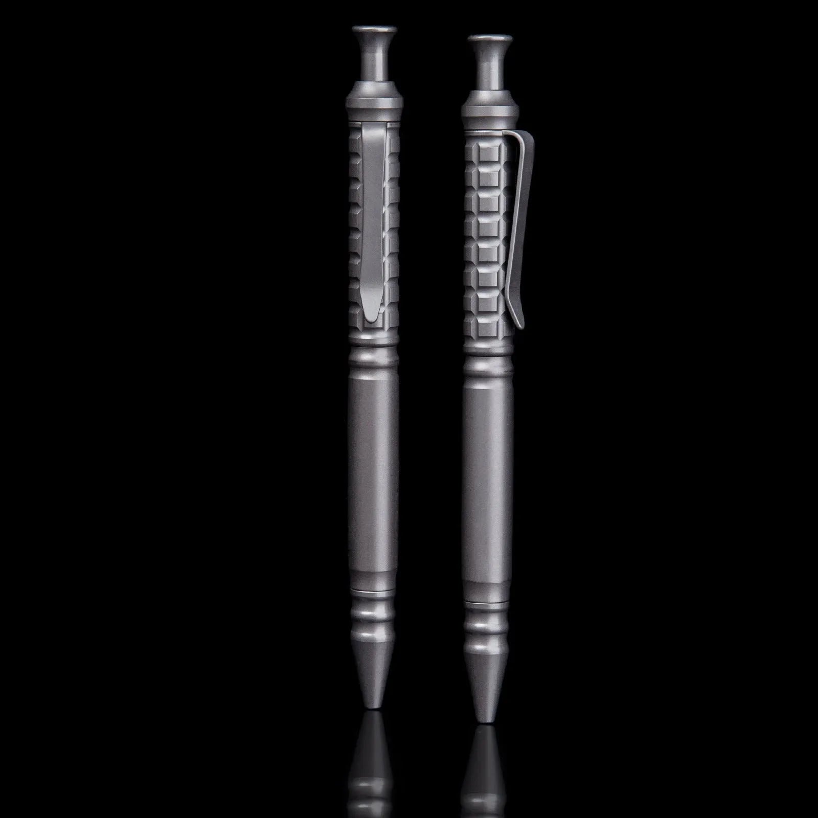 Gunmetal grey titanium alloy tactical pen with push-action decompression mechanism