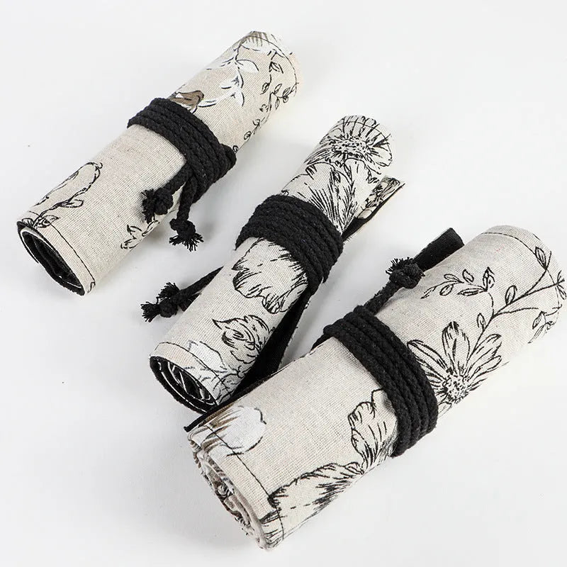 Black peony floral print canvas pencil roll bag unrolled to show 24 pencil sleeves