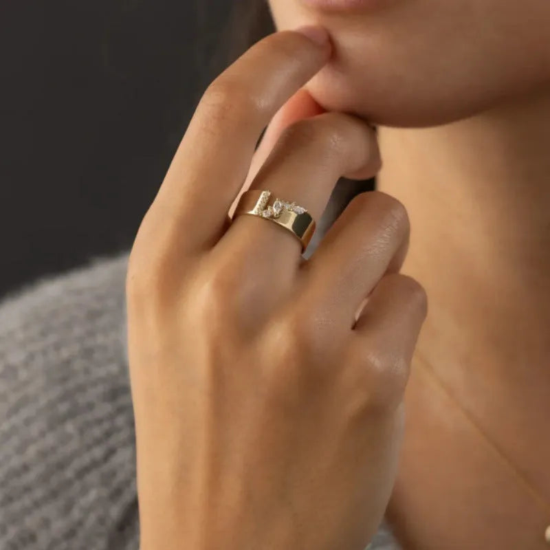 Gold electroplated women's ring with shining zircon stone on a copper band.