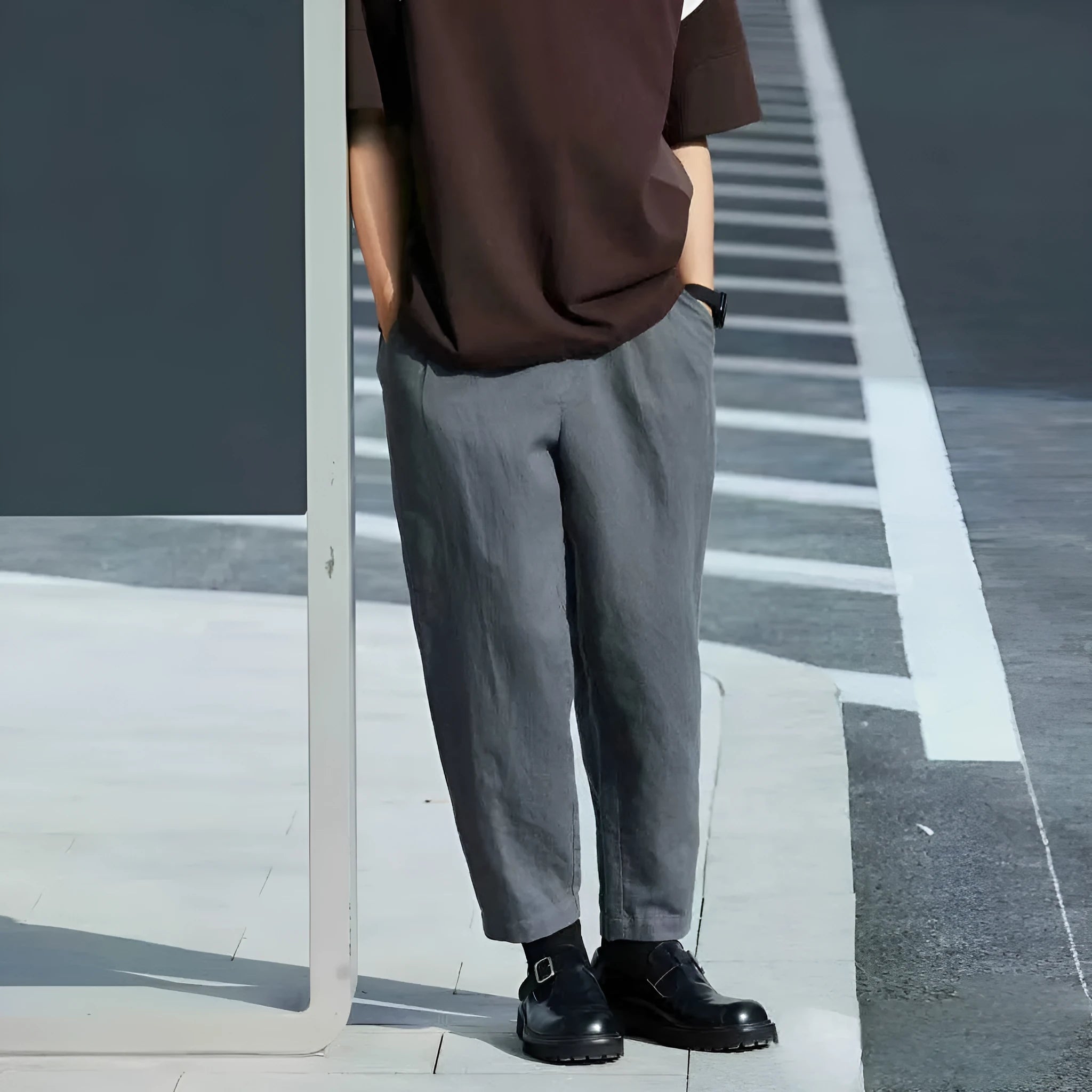 Man wearing beige loose-fit straight-leg casual trousers with a drawstring waistband.