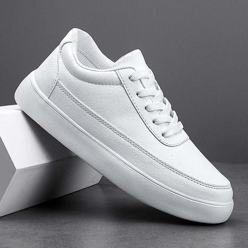 Women's white leather lace-up casual flat shoes on a plain background.
