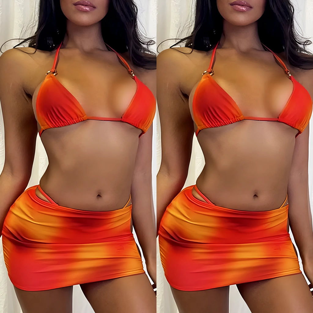 Women's tie-dye gradient halter neck bikini top and skirt three-piece swimsuit set on a beach background