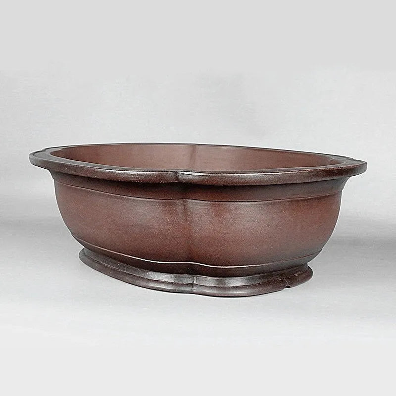 Handmade antique crabapple shaped purple clay flowerpot for plants.