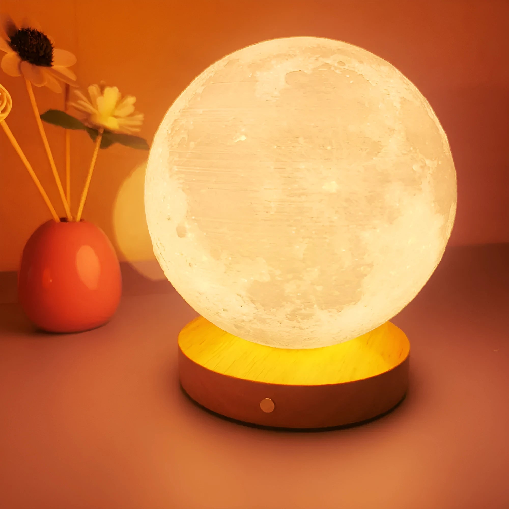 Rotating moon night light on wooden base showing three colour options and size scale