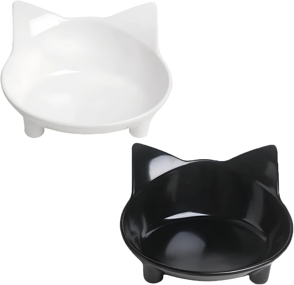 Shallow black and white melamine pet bowls with non-slip rubber bases on a kitchen floor.