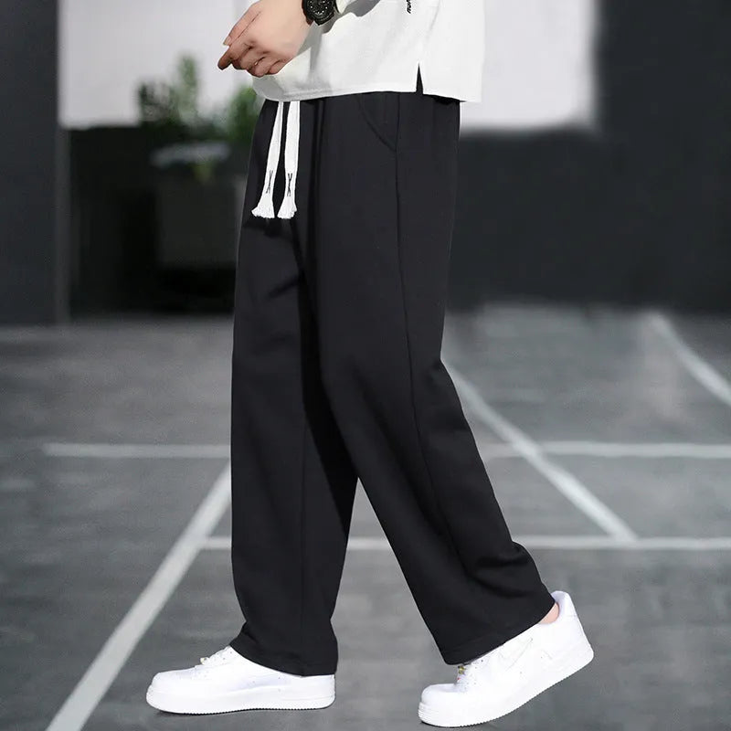 Men's grey Ninth Sports Pants showing high waist and multiple pockets.
