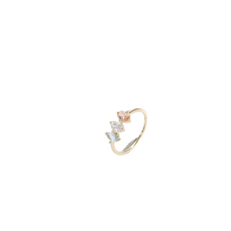 Geometric copper ring with a triangular tricolour zircon birthstone in a horse eye design, showing 14k gold electroplated finish.