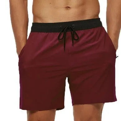 Men's blue stitching waist drawstring running shorts with a zipper pocket and integrated headband.