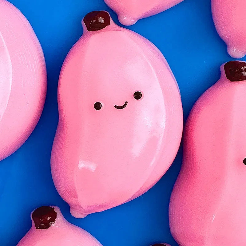 Chubby Banana Squeezing Toy in pink and green TPR material for stress relief
