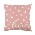 Square red and white plaid cushion cover with heart motifs, measuring 45cm, on a grey sofa.