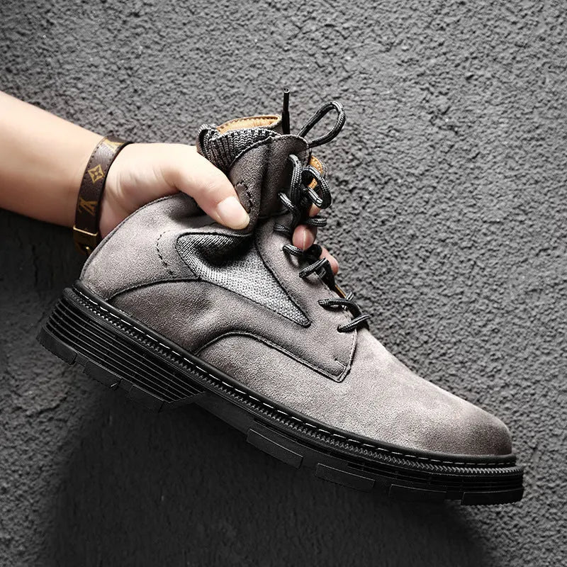 Men's frosted brown Martin boots with round toe and thick rubber sole on a wooden surface.