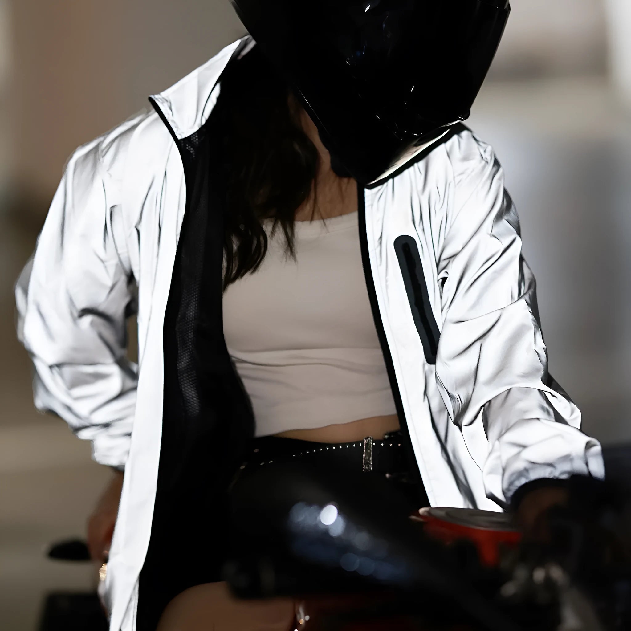 Silver waterproof polyester long sleeved jacket showing front view with size label indicating Asian and European conversion