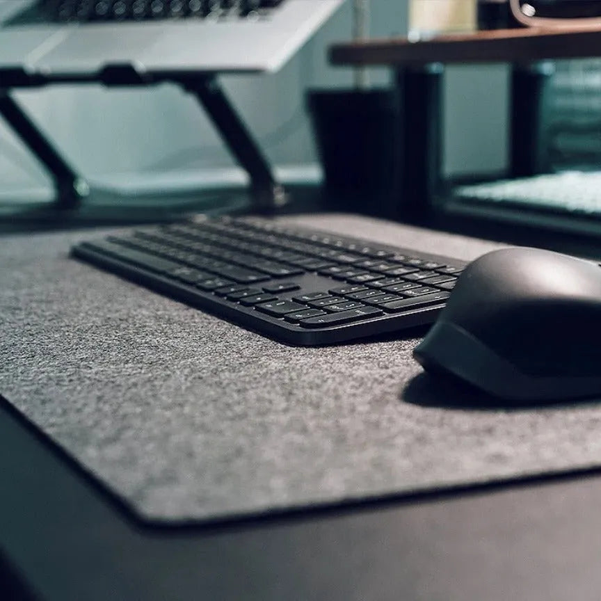 Extra large felt mouse pad in brown, black, grey, or light grey with non-slip backing and machined edges.