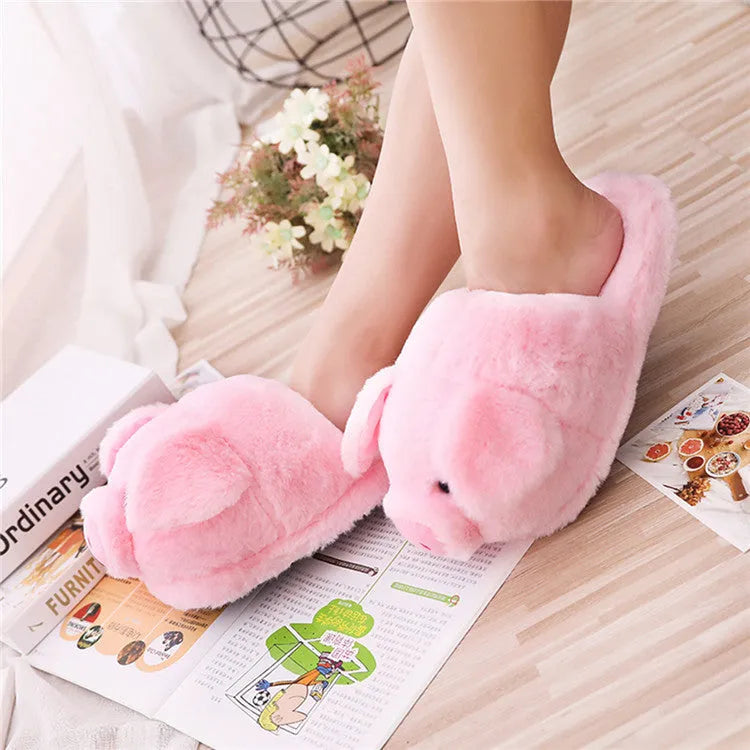 Pink adult pig-shaped floor slippers with short plush fabric on a white background.