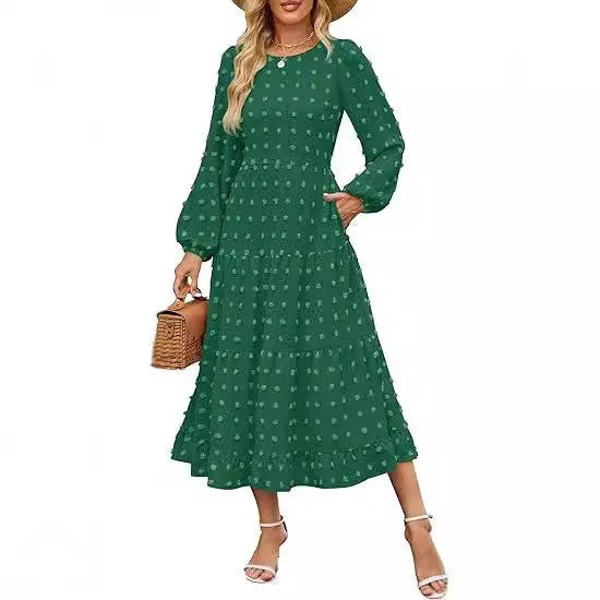 A woman wearing a beige high-waist long sleeve dress with ruffle detailing on the sleeves.