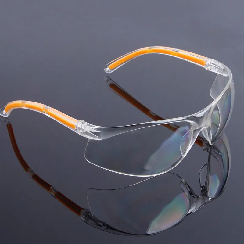 Transparent polycarbonate safety goggles with yellow tinted lenses for eye protection.