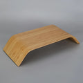 Walnut stability bracket laptop stand in bamboo leather colour, 23x51x9cm, on a desk