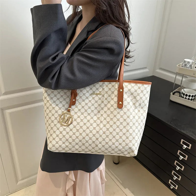 PU leather shoulder bag with adjustable strap in black, shown with visible stitching detail.