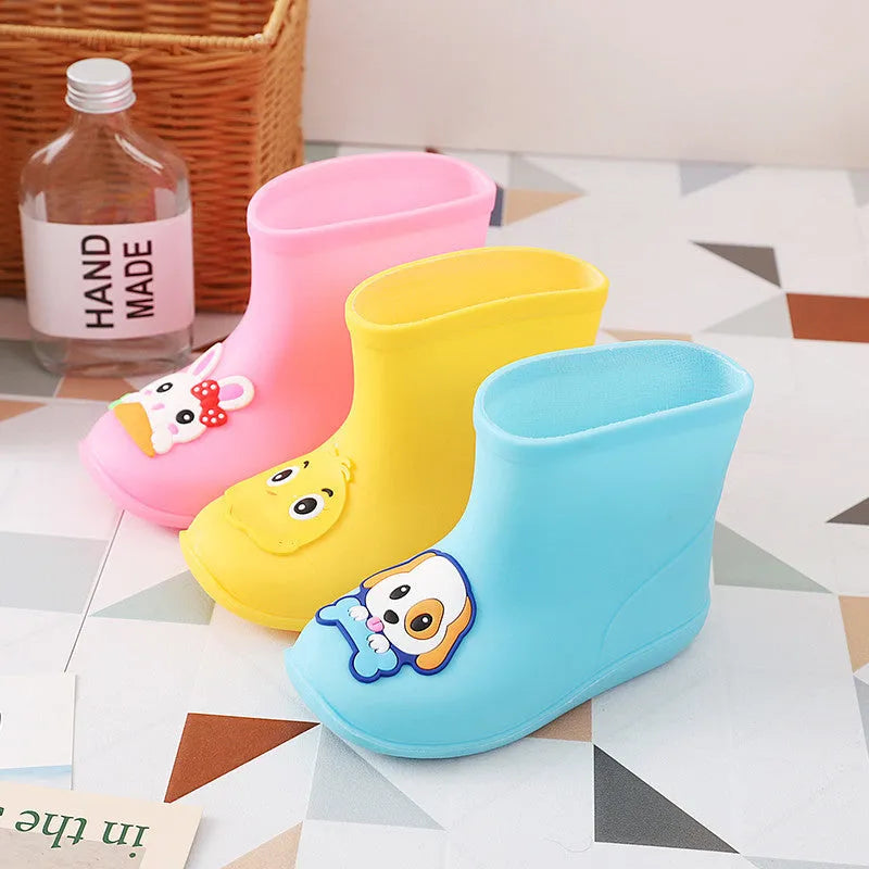Children's short rain boots in yellow, pink, or blue with non-slip sole, waterproof PVC upper, cartoon pattern, sizes 14-18