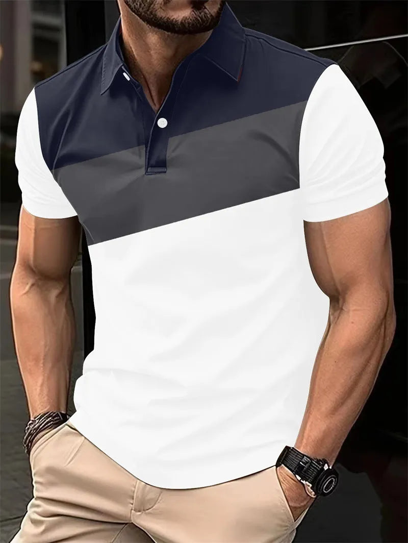 Man wearing a loose fit grey T-shirt with a colourful 3D digital graphic print on the front.