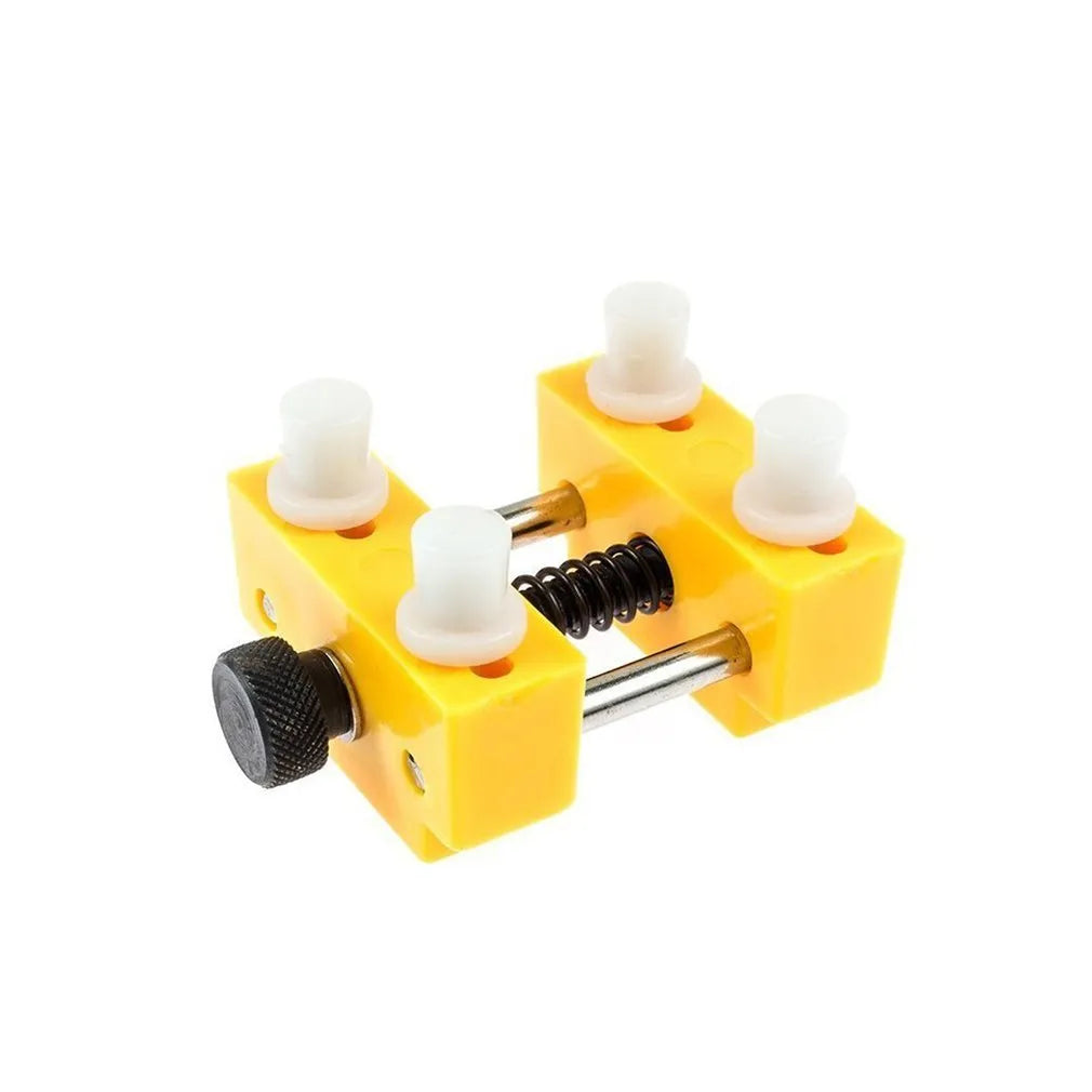Yellow plastic watch case opener tool and fixing base with four pillars for DIY repair.