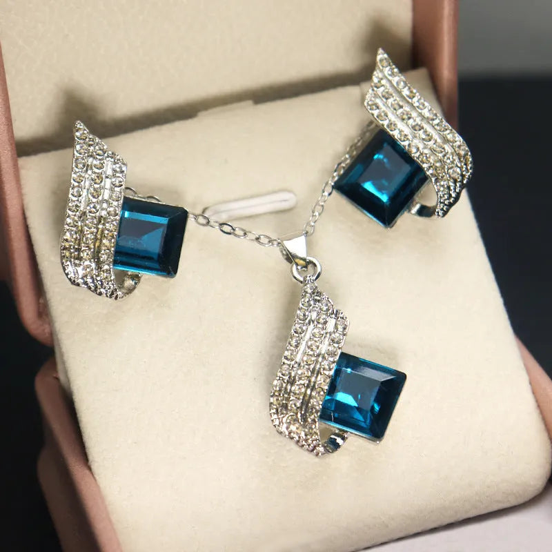 Women's electroplated alloy and glass jewellery set showing necklace with cross chain design and matching ear studs