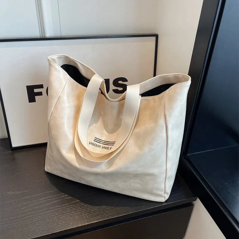 Large capacity PU tote bag for women in solid black, beige or brown, waterproof shoulder handbag for daily and travel use.