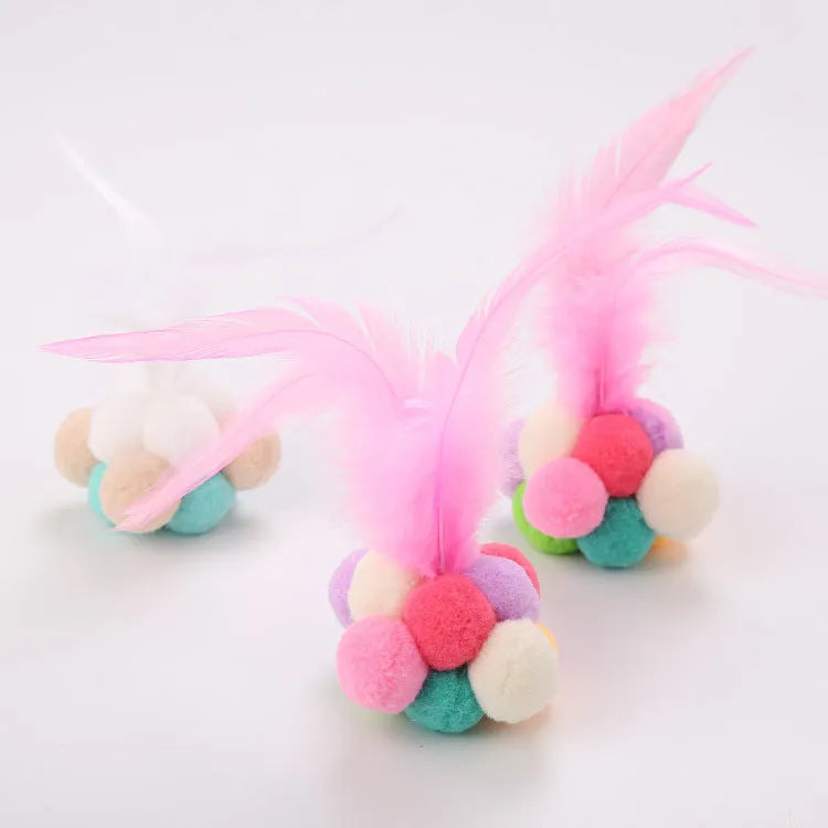 Cat toy feather bouncy ball with colourful pink feathers and blue white feathers for interactive play