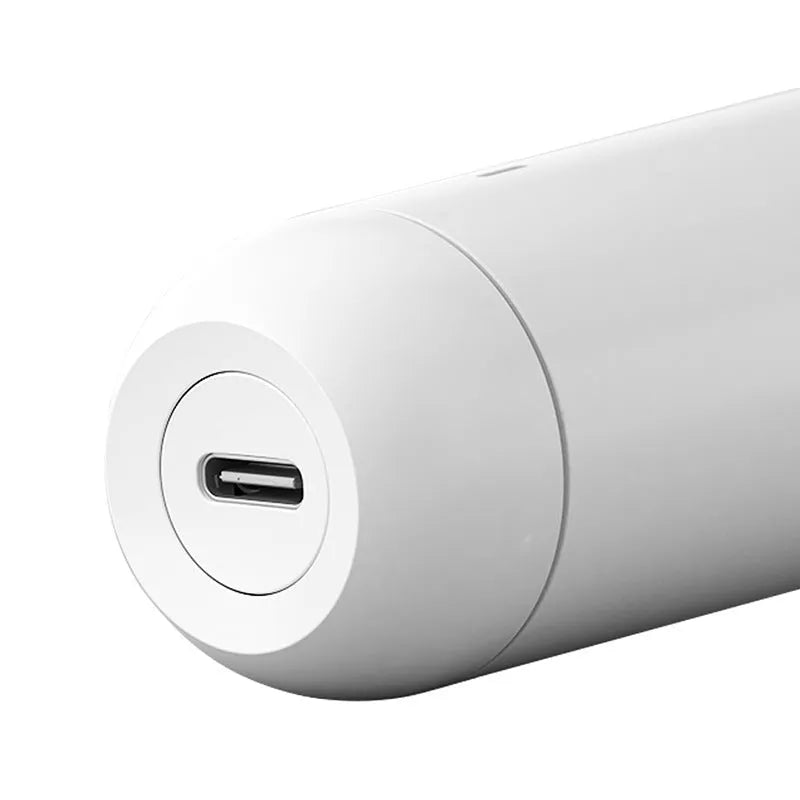 White wireless karaoke microphone with built-in speaker and metal mesh grille on a plain background