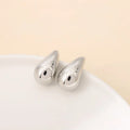 Minimalistic water drops earrings in gold plated copper, drop shape stud style on white background