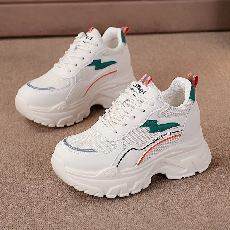 Women's white breathable dad shoes with cross strap and lace-up front on a rubber sole.