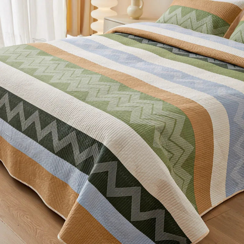 Pure cotton printed bed sheet three-piece set laid out on a bed, showing a modern pattern.