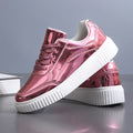 Gold sequin platform sneakers with a round toe and 3-5cm mid heel on a white background