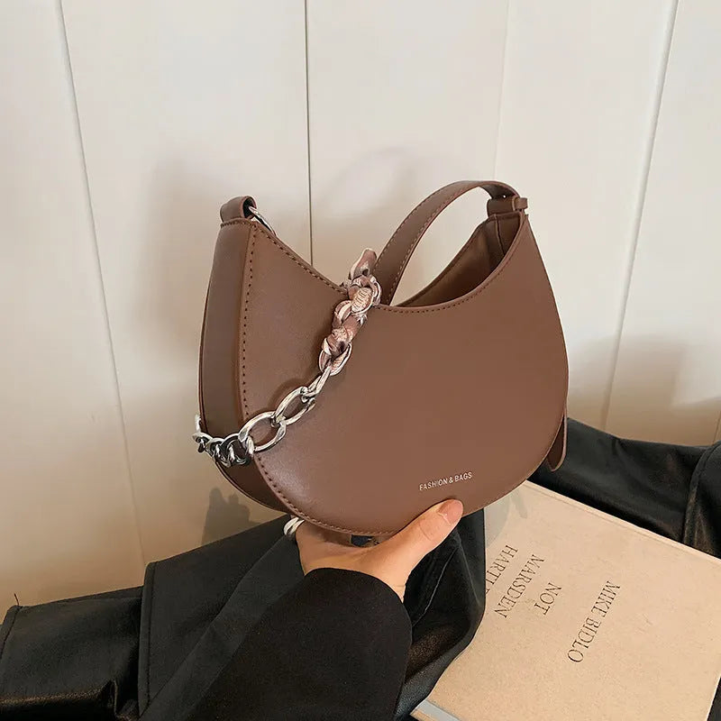 Small PU saddle shoulder bag with sandwich pocket and phone compartment, shown in black, brown, coffee, green, khaki or white.