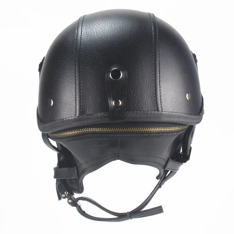 Retro black leather motorcycle helmet with a half-visor on a background.