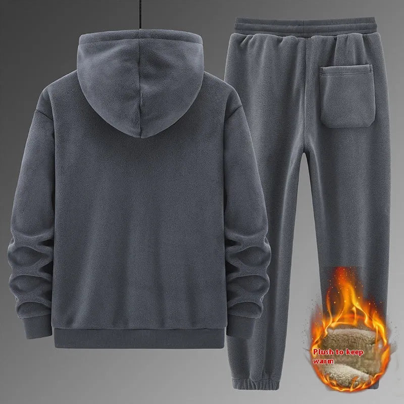 Man wearing a grey hooded sweater and matching trousers from a casual sports suit set.