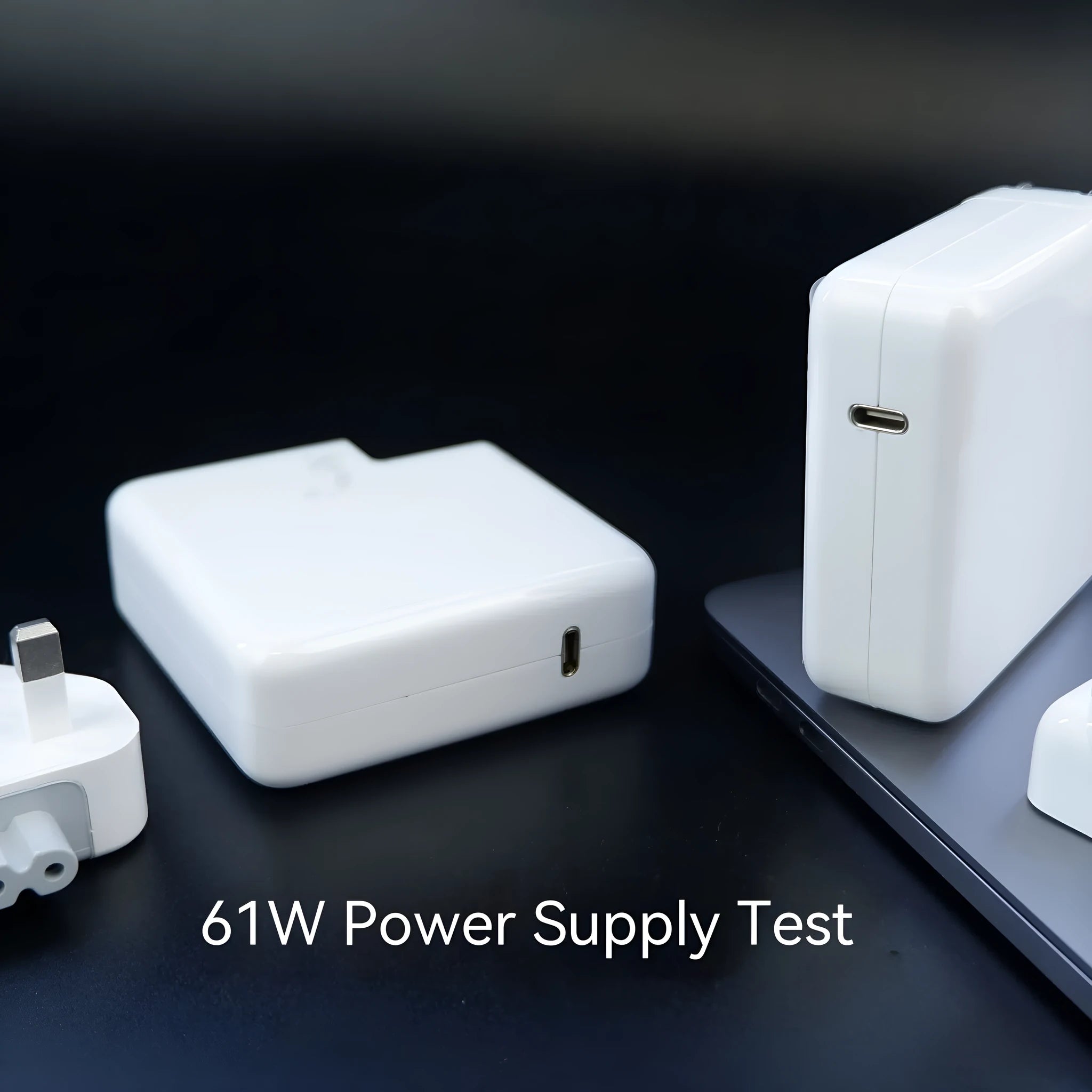 61W USB-C laptop charger with international UK EU US AU plugs measuring 7x7x3cm