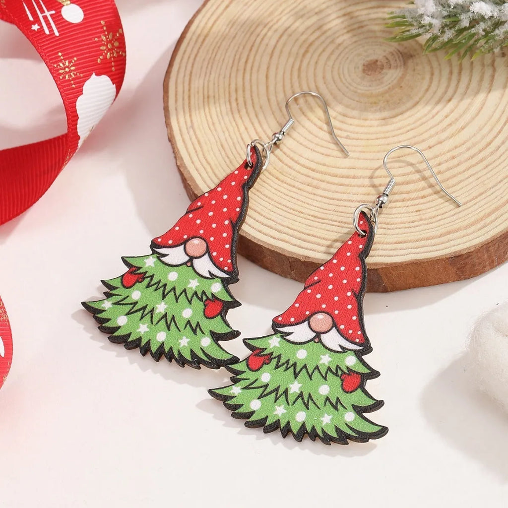 Wooden geometric Christmas earrings with printed festive designs on a white background.