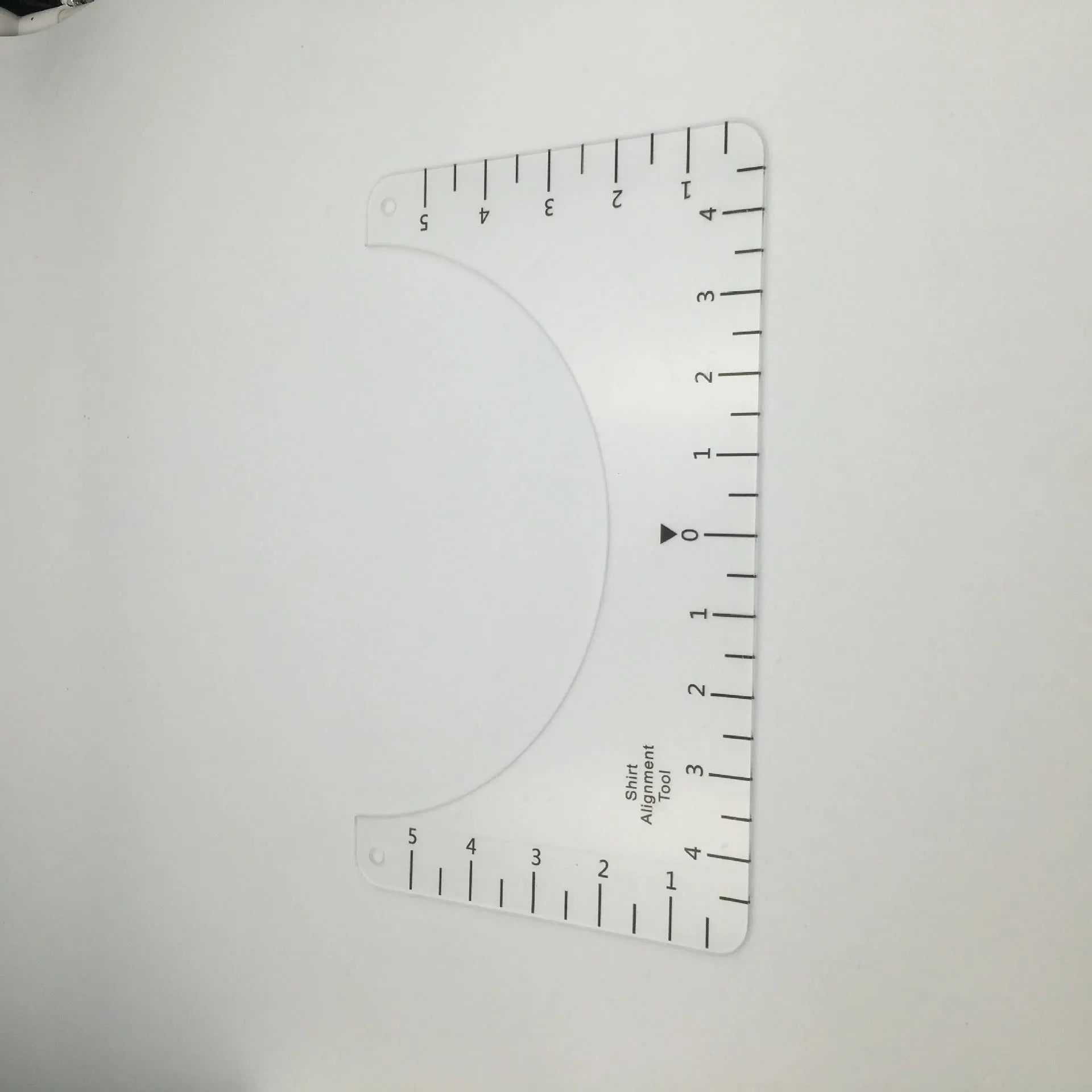 Transparent acrylic sewing ruler measuring 10 by 6 inches for T-shirt patch alignment