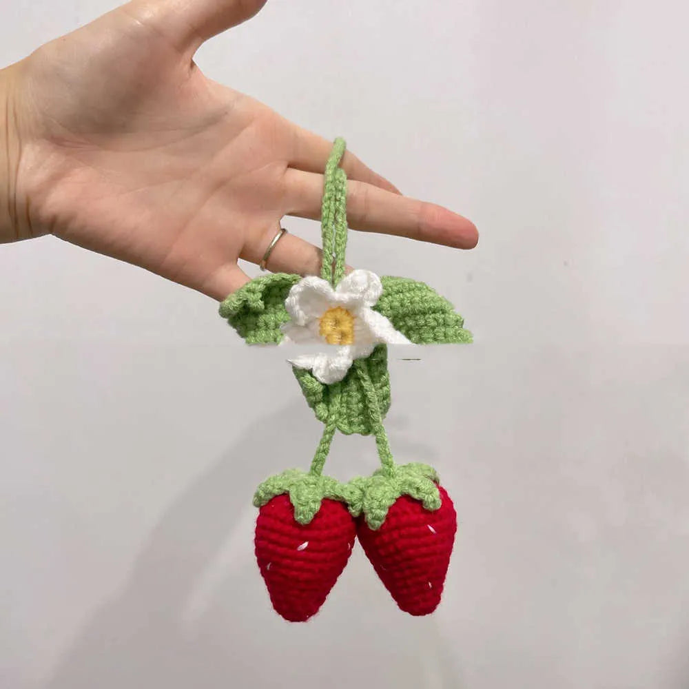 Handwoven strawberry-shaped car pendant made from cotton and hemp fibres.