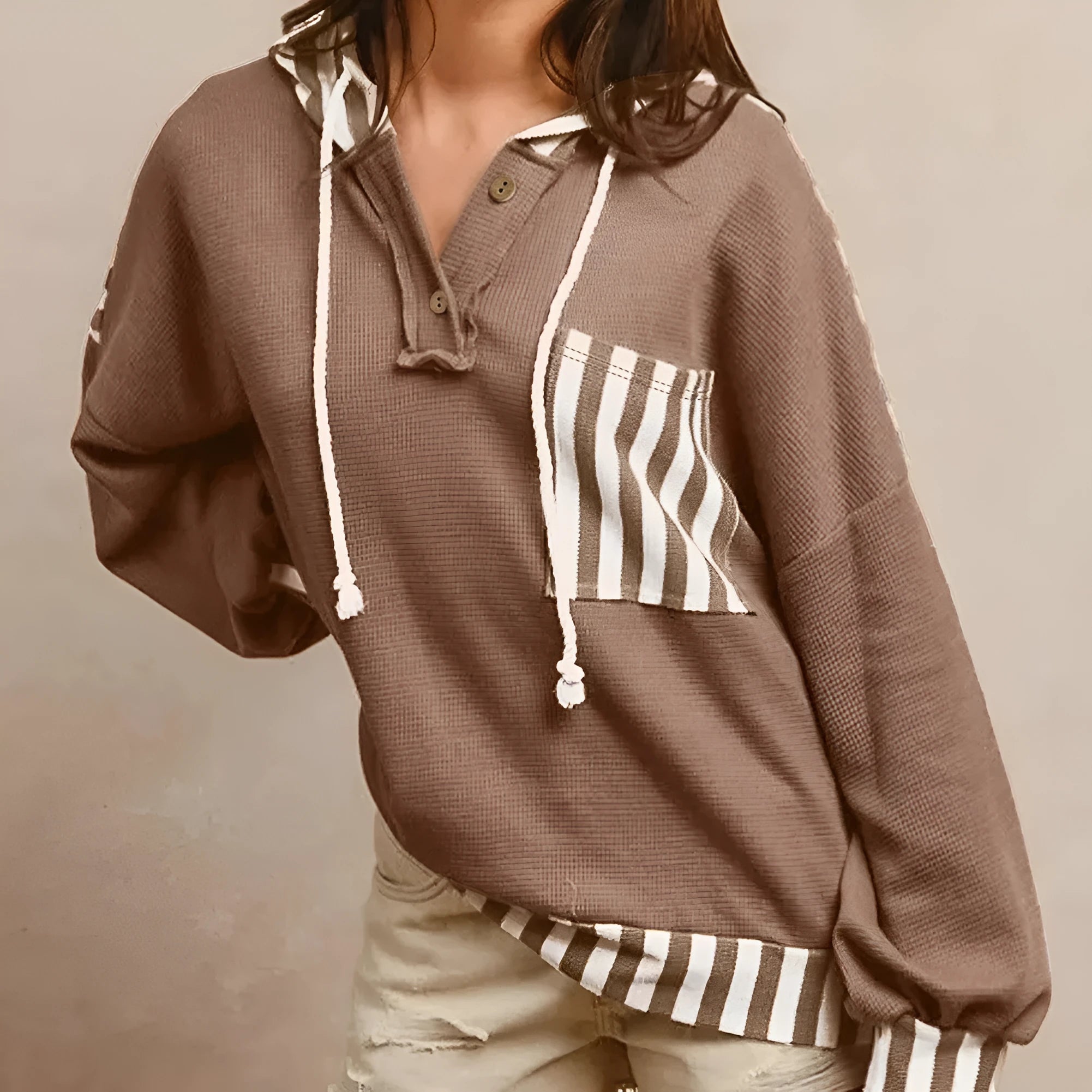 Straw yellow hoodie with waffle texture, striped patchwork, a button neck, and a drawstring hood.