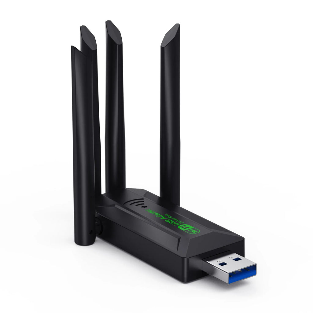 Black USB network transmitter with four external antennae for computer Wi-Fi signal boosting.