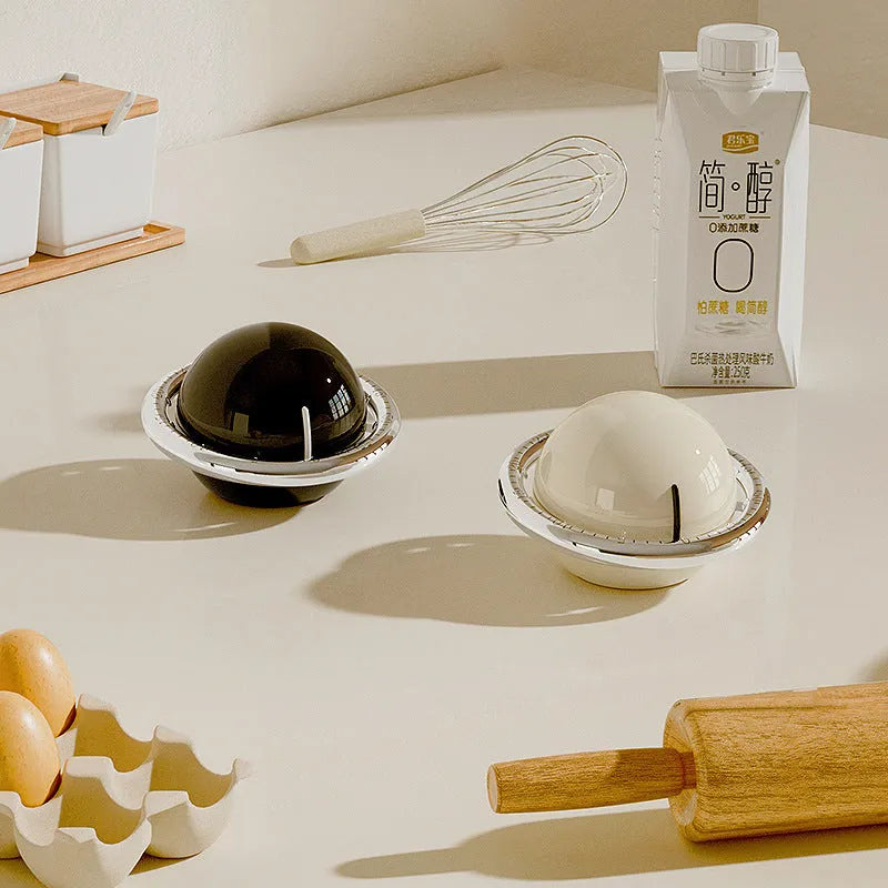 Mechanical kitchen timer in beige or black with manual twist dial and magnet backing, no battery required.